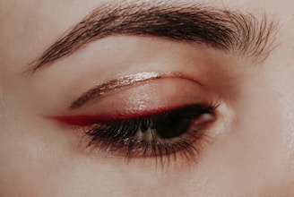 person with red lipstick and black mascara