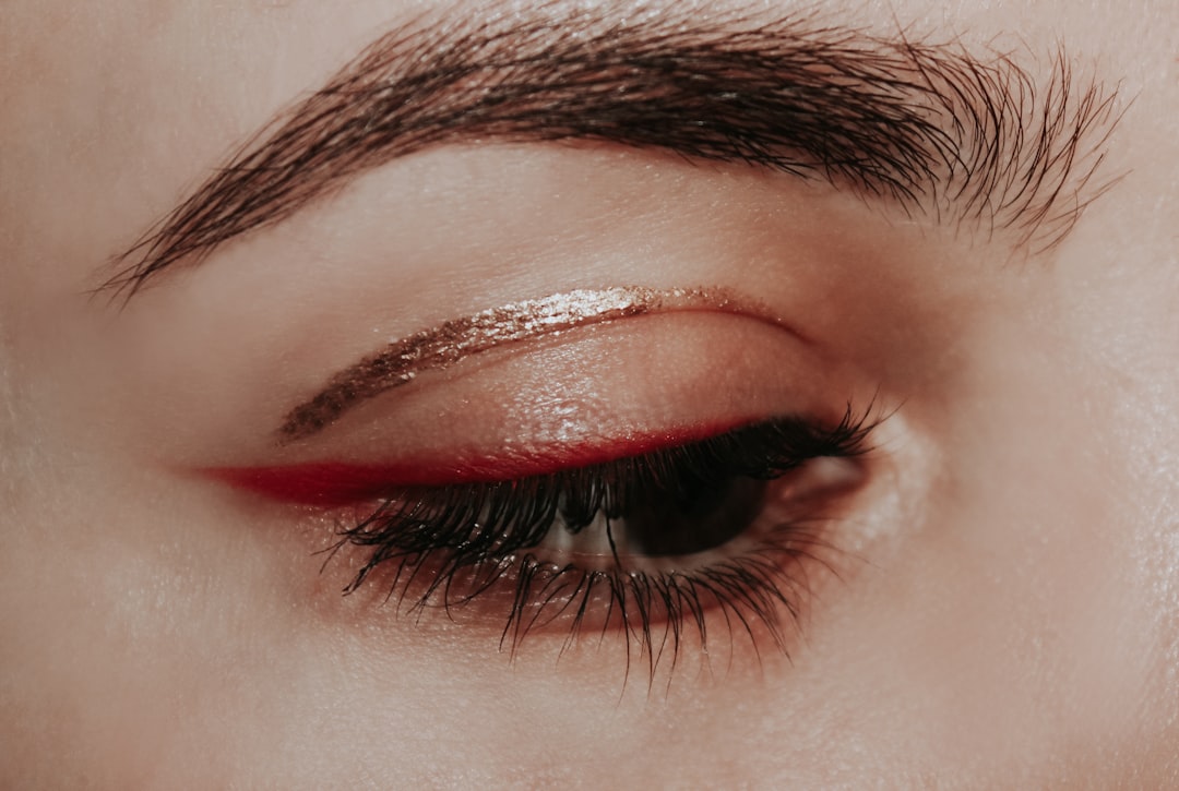person with red lipstick and black mascara,