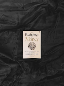 yellow and white book on black textile