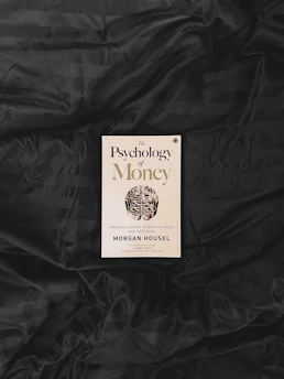 yellow and white book on black textile