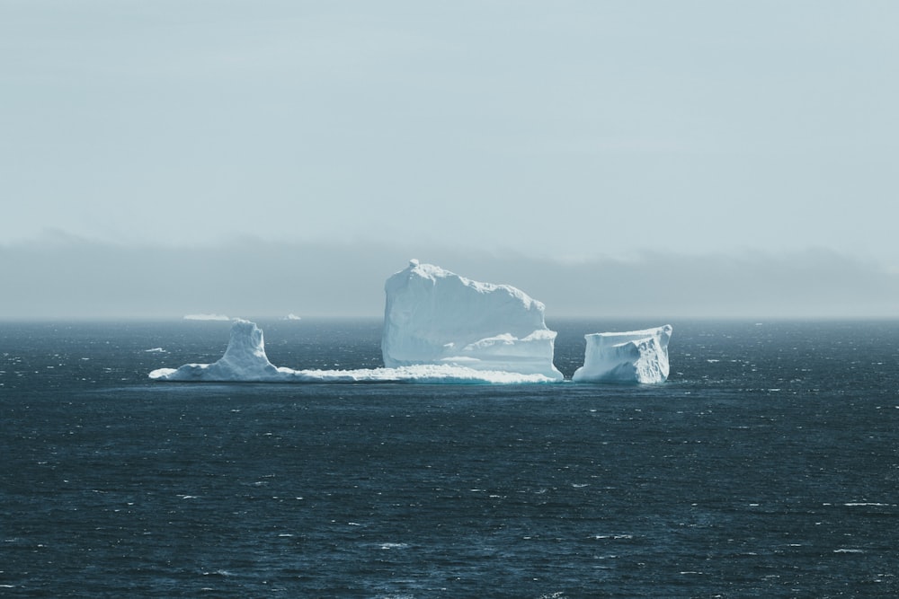 grayscale photo of rock formation on sea