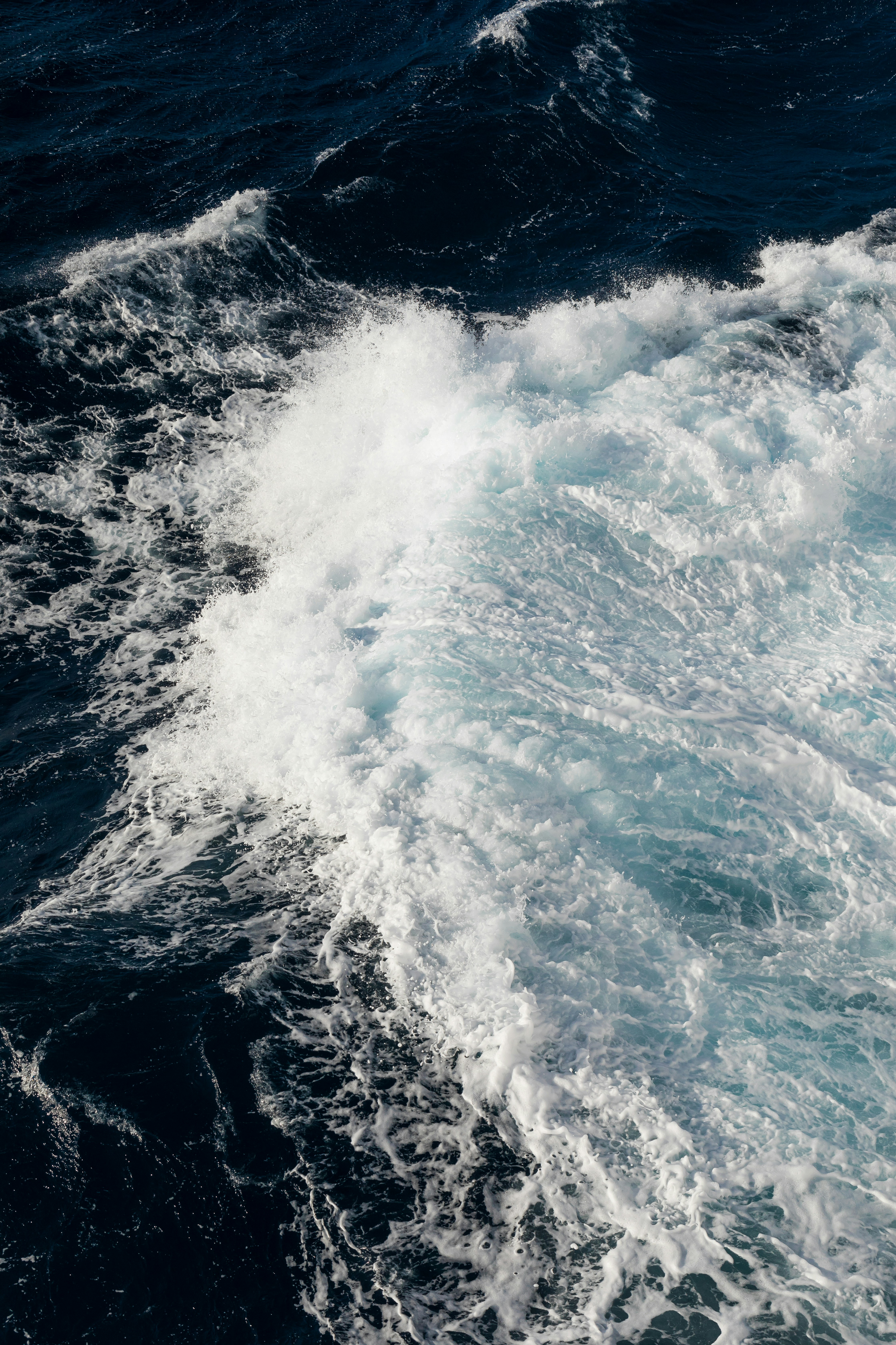 ocean waves crashing on shore during daytime