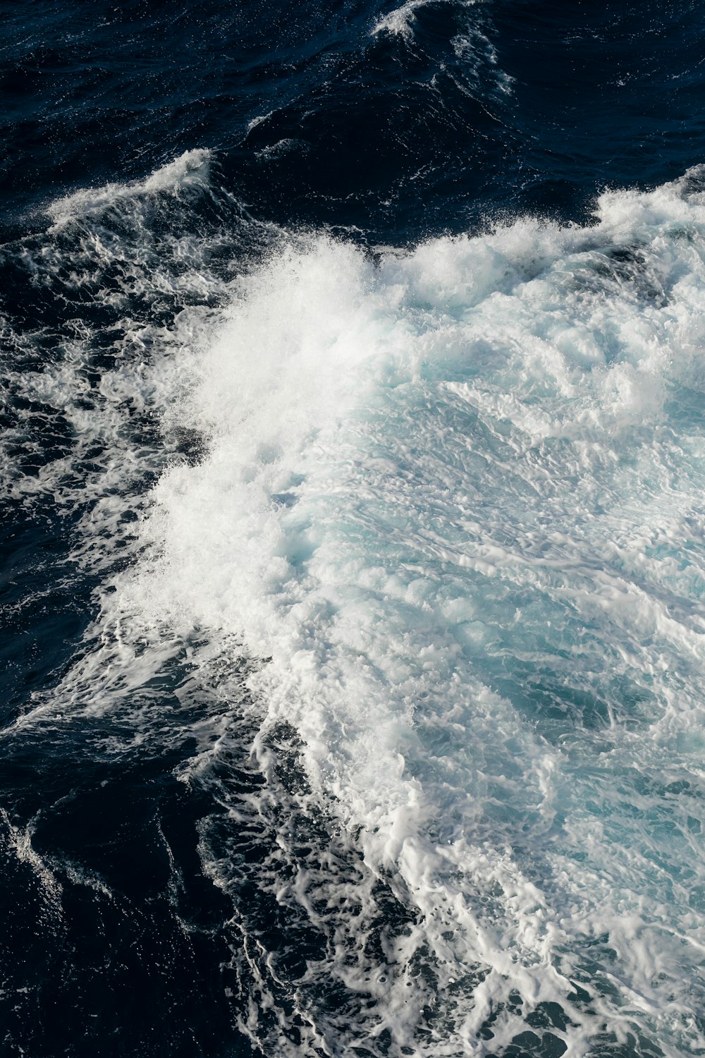 ocean waves crashing on shore during daytime