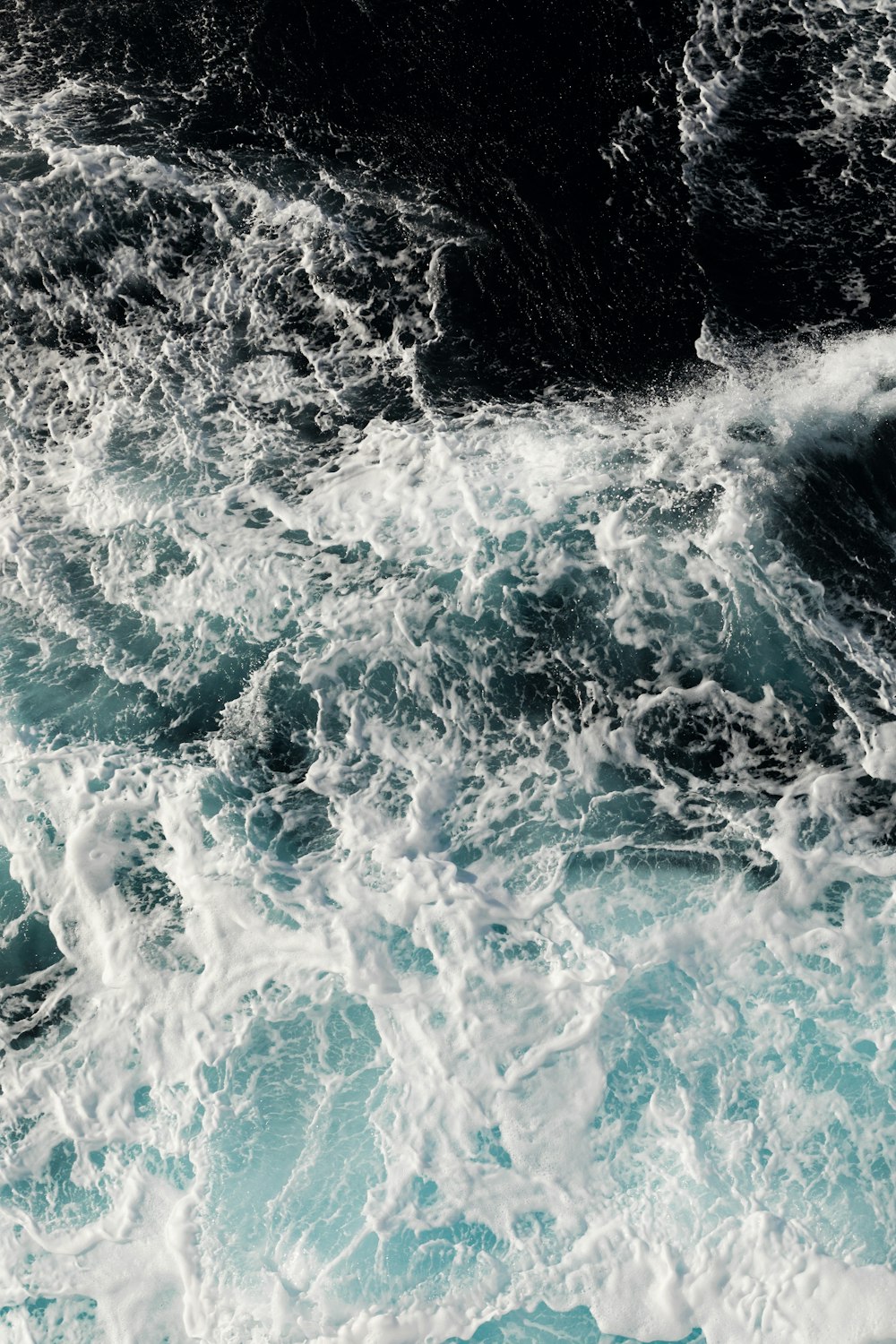 water waves on blue body of water during daytime