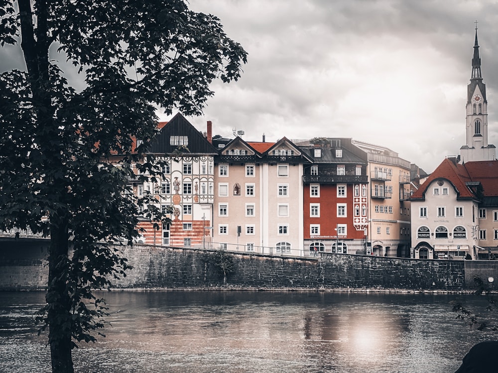 red and white concrete building beside river during daytime