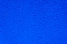 water droplets on blue surface