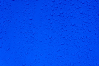 water droplets on blue surface