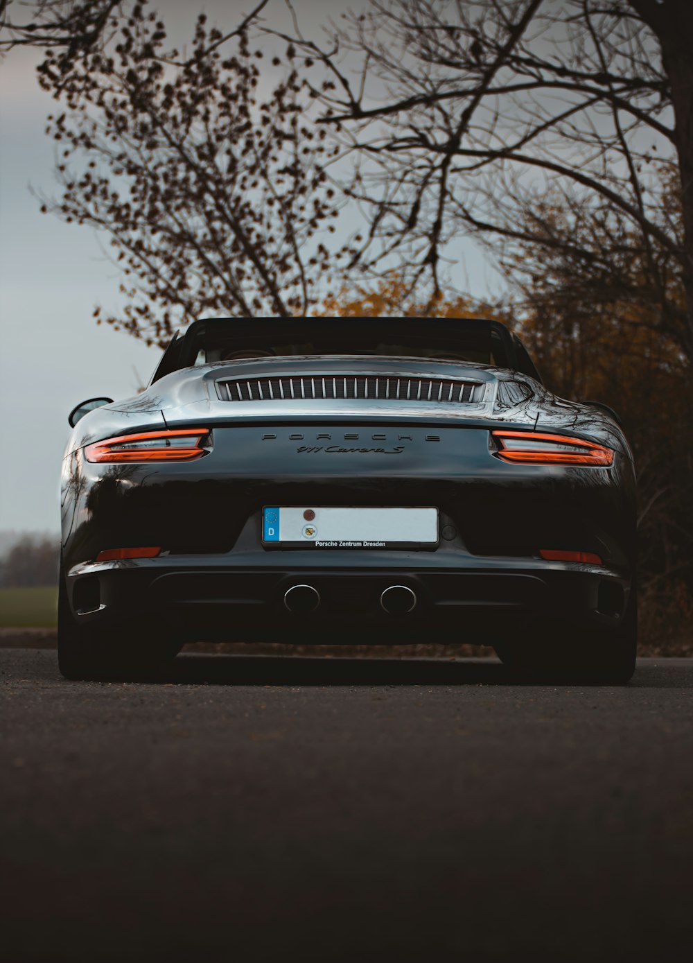 black and white porsche 911 on road