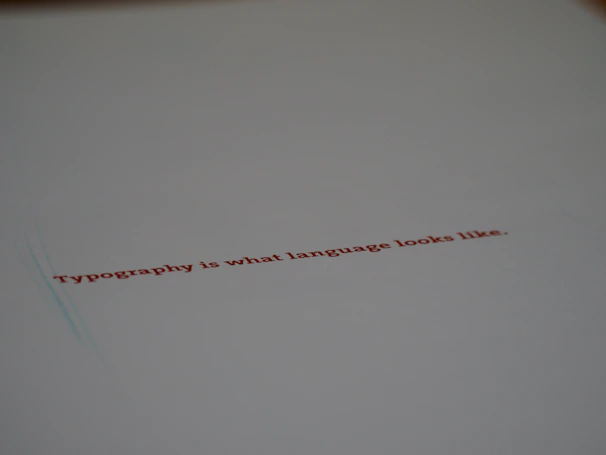 Close-up of a minimalist editorial layout featuring elegant typography on a beige background.
