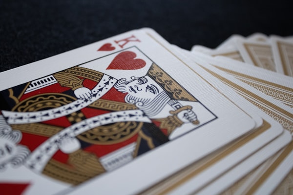 Playing cards spread on a table with the king of hearts face up on top