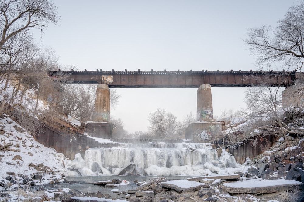 brown bridge over water falls