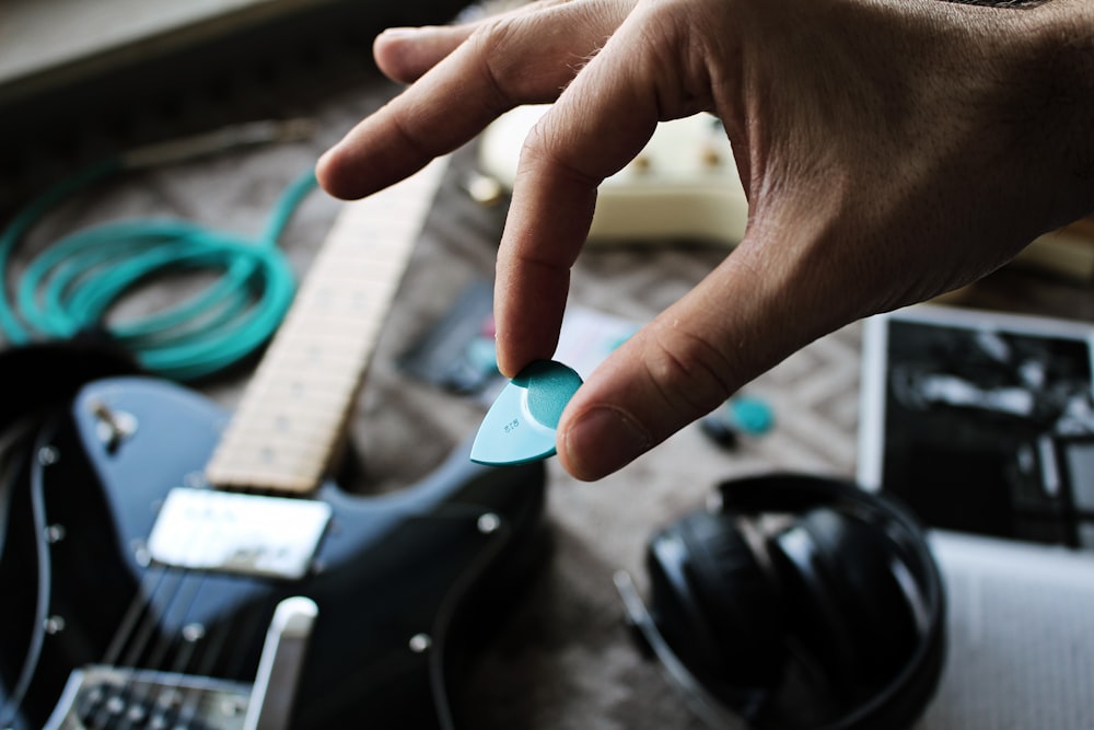 person holding blue and white plastic tool