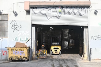 yellow and black auto rickshaw parked beside white and black store
