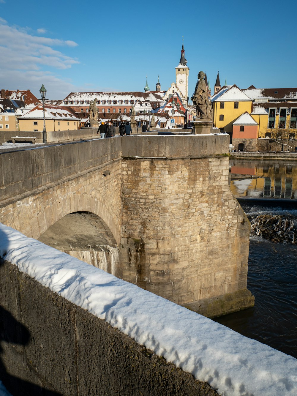 people walking on concrete bridge during daytime