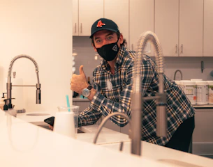 man in black and white plaid dress shirt wearing black helmet