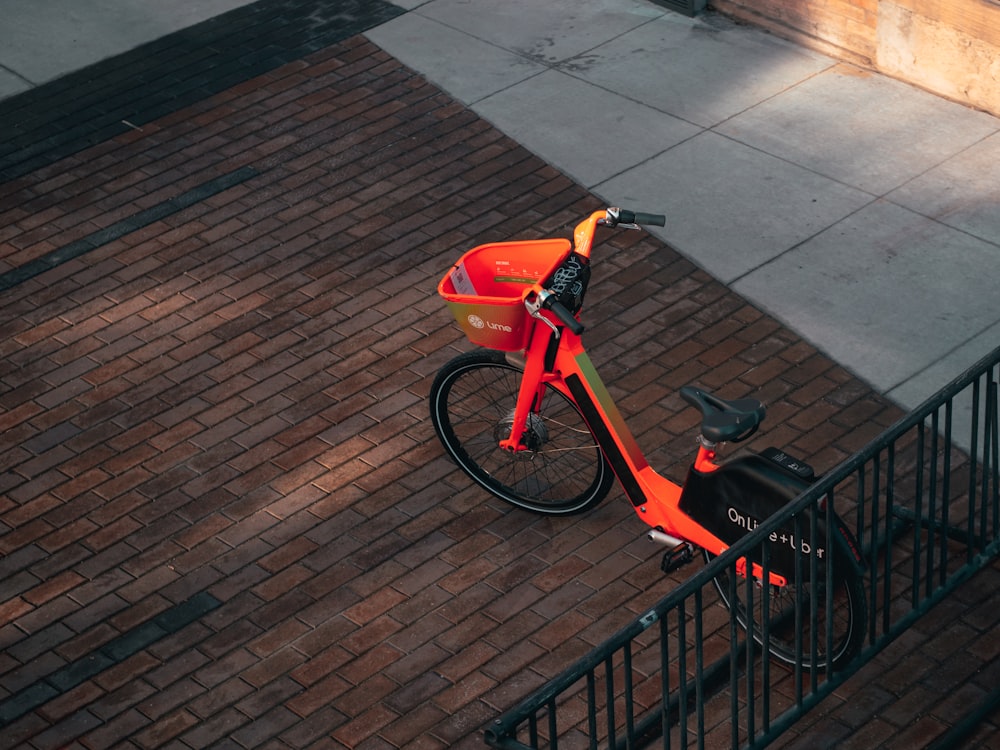 red and black bicycle on brown brick floor