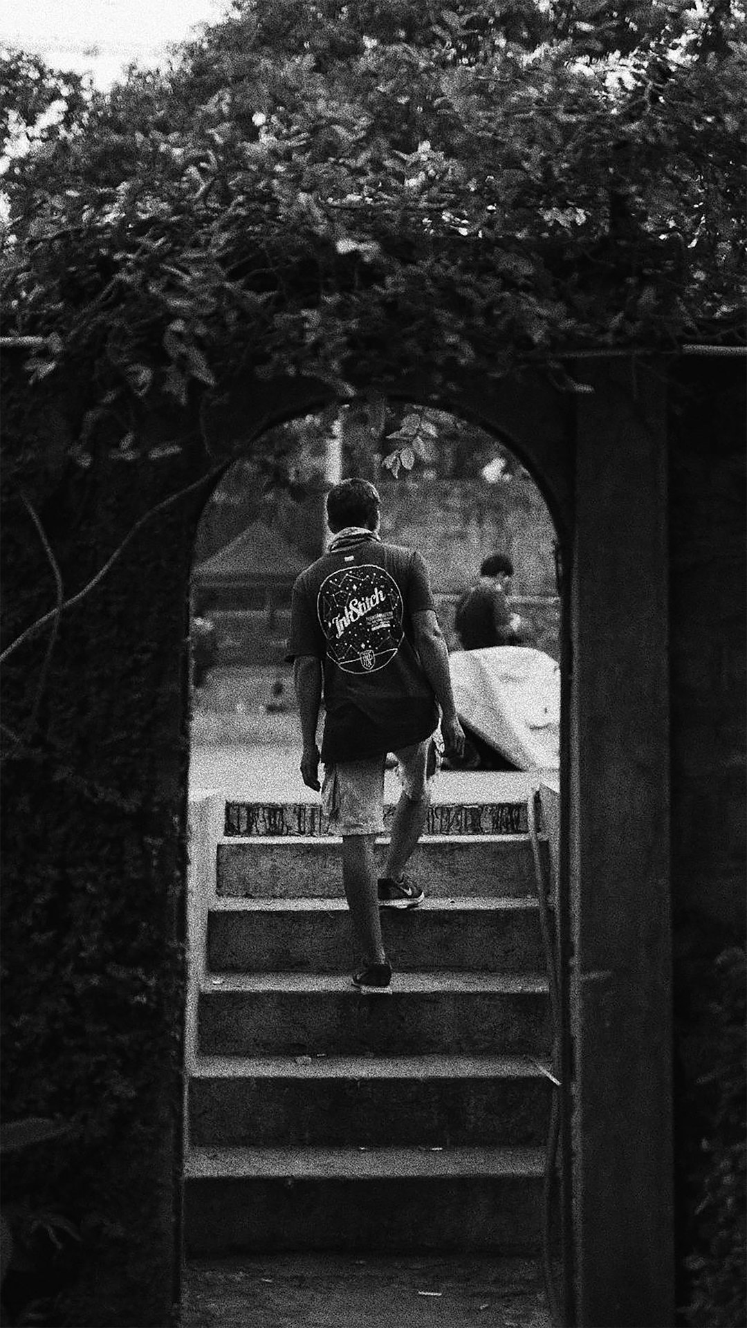 man in black t-shirt and black pants sitting on stairs