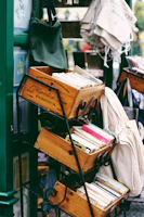 Stacks of colorful books ready for reuse, neatly arranged on tables outdoors.