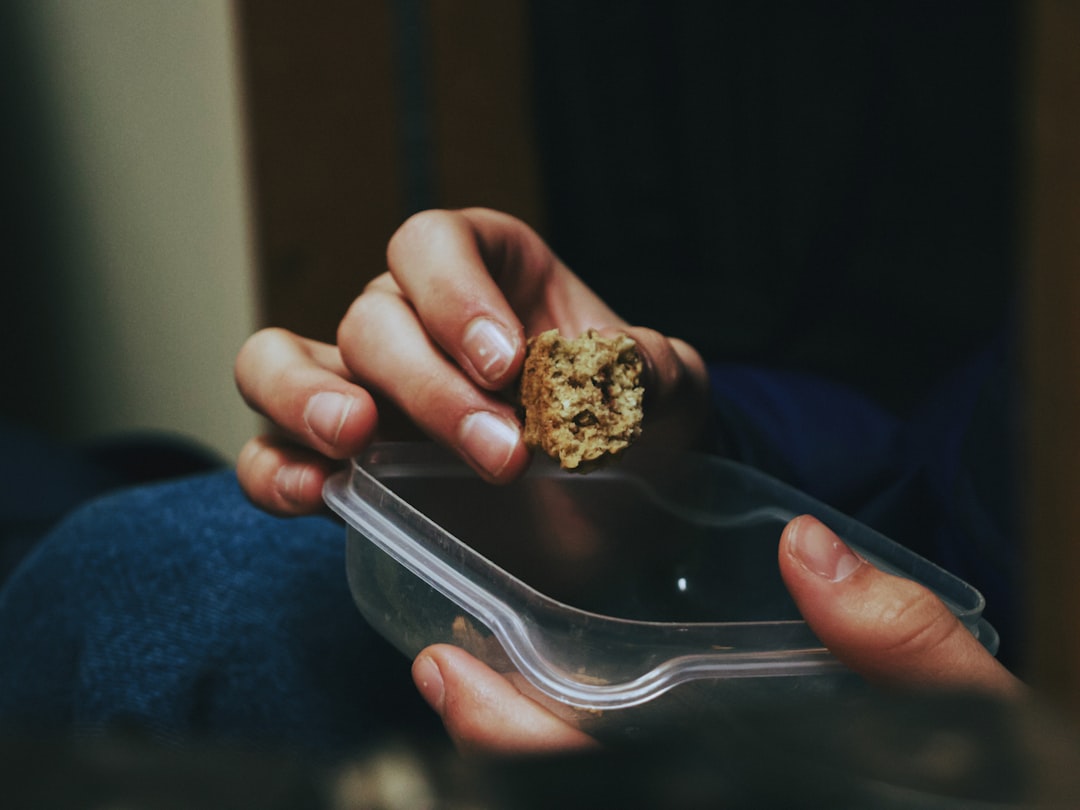 person holding brown and green kush