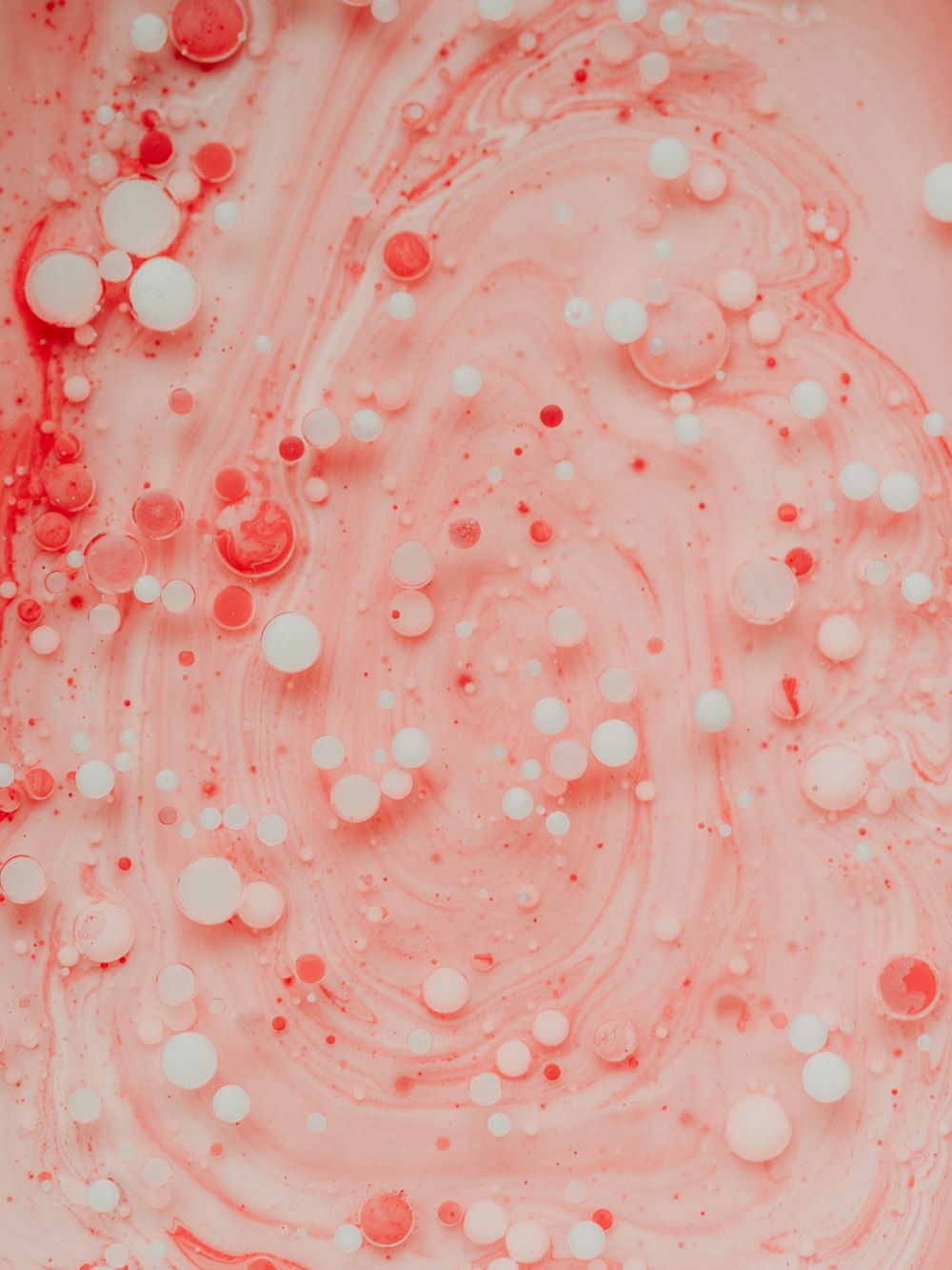 pink and white bubbles on water