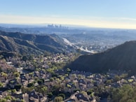 A panoramic shot of a serene locality with clean streets and contemporary homes under a bright sky.