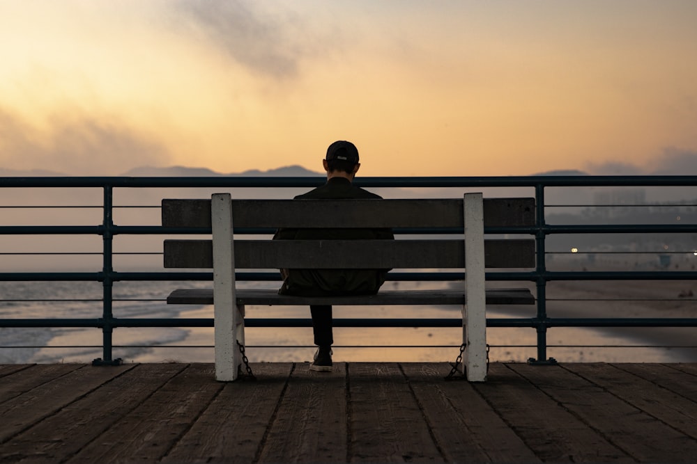 man sitting on bench during daytime