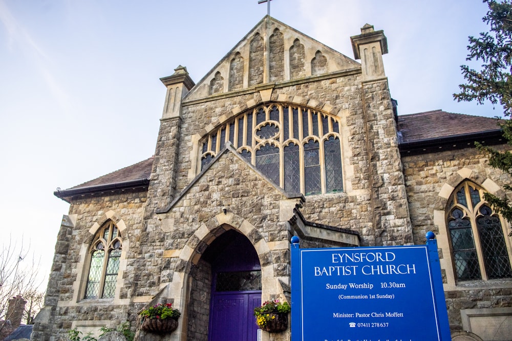 brown brick building with blue and white signage