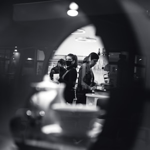 Photo of a clean, modern kitchen renovation in progress with workers coordinating tasks.