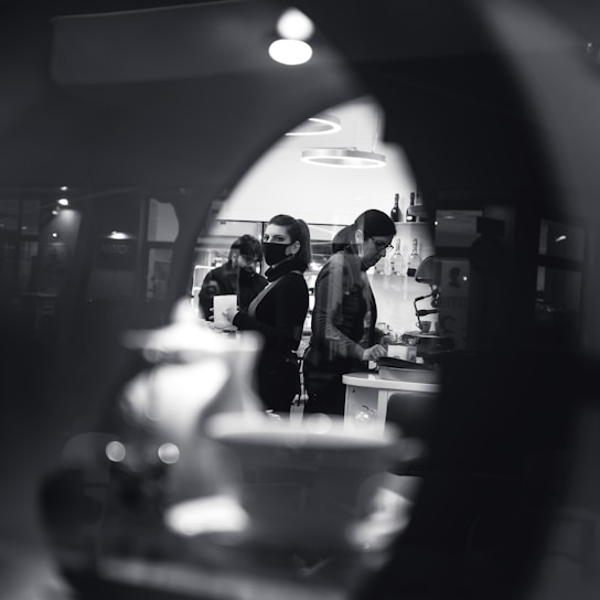 Photo of a clean, modern kitchen renovation in progress with workers coordinating tasks.