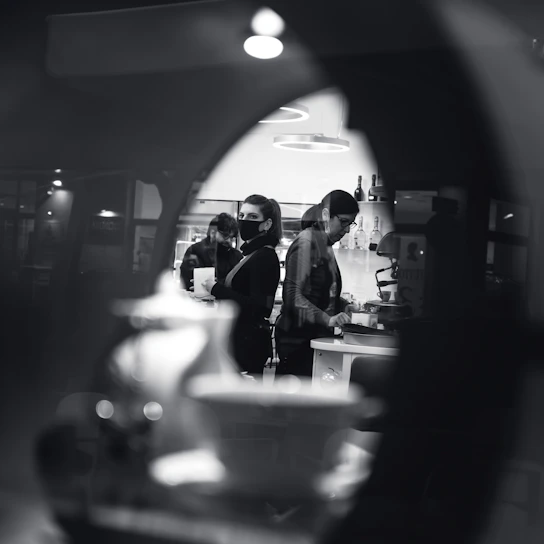 Authentic photo of the Alcon team preparing fresh, artisanal food in a warm, natural kitchen setting.
