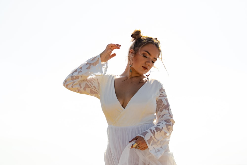 woman in white and brown floral long sleeve dress