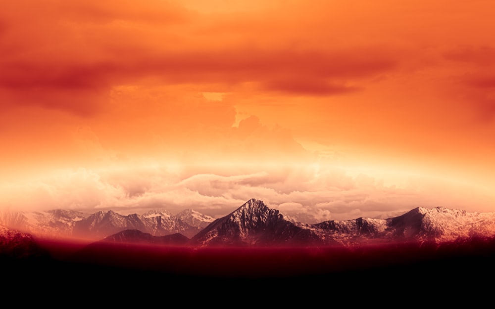 snow covered mountains during sunset