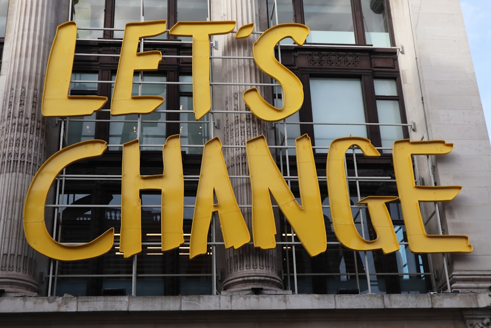 a sign that says let's change on a building