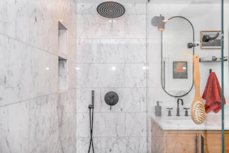 Cozy bathroom showcasing marble tiles and a rainfall showerhead.