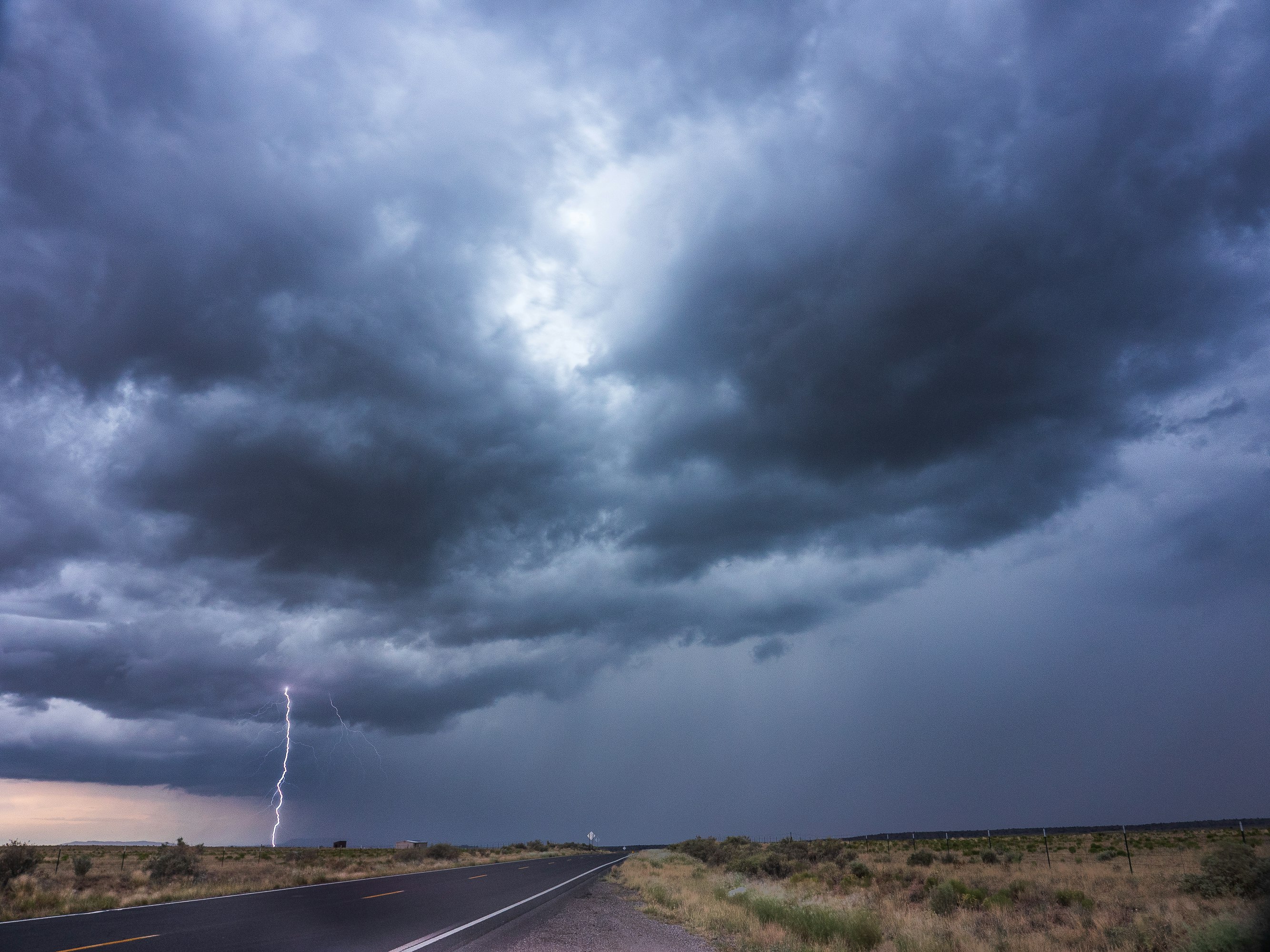 gray asphalt road under gray clouds