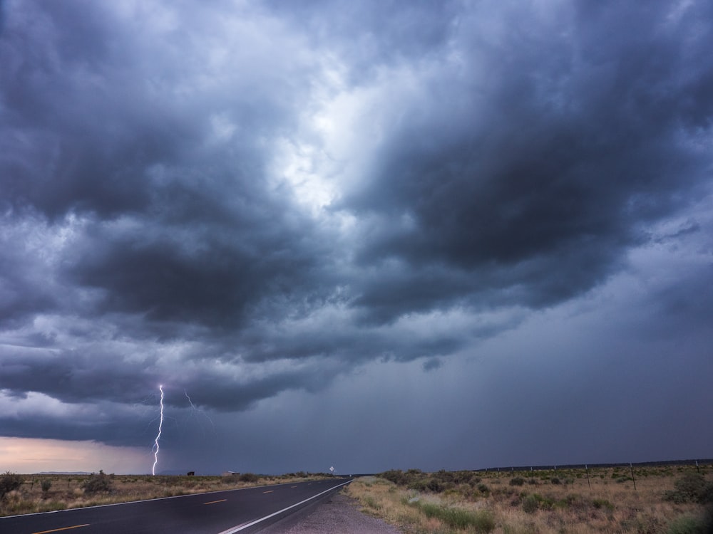 gray asphalt road under gray clouds