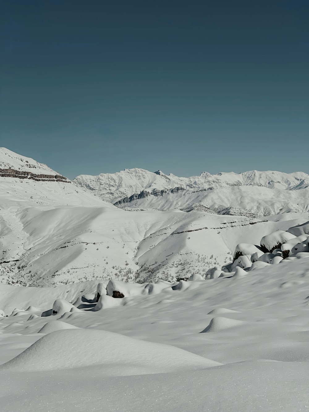 a man riding skis down a snow covered slope