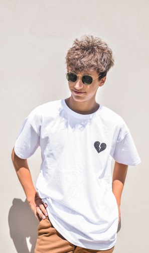 boy in white crew neck t-shirt wearing black sunglasses