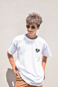 boy in white crew neck t-shirt wearing black sunglasses
