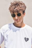 man in white crew neck shirt wearing black sunglasses