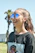 A close-up photo of a happy woman wearing stylish vidade sunglasses outdoors on a sunny day.