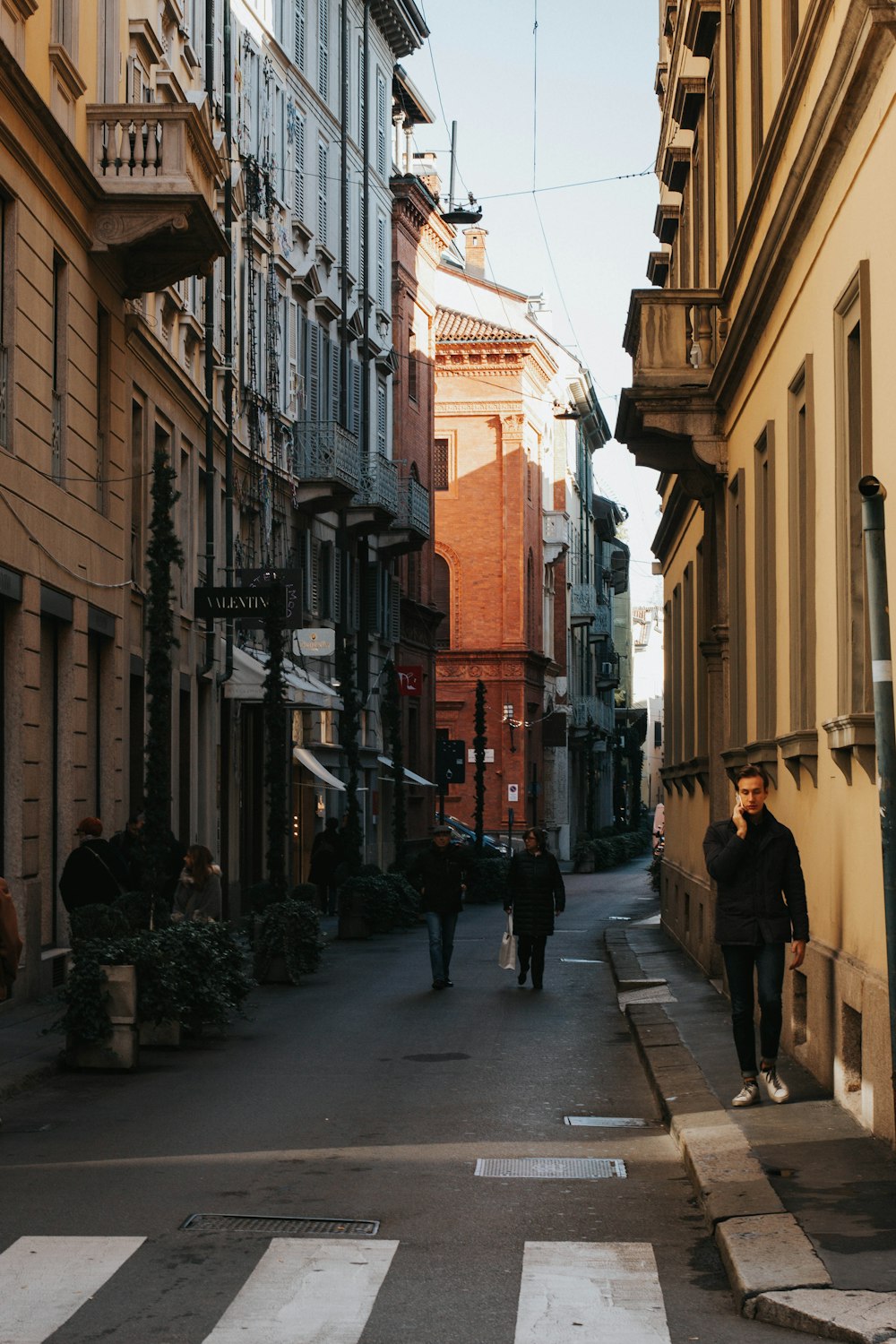 people walking on sidewalk near buildings during daytime