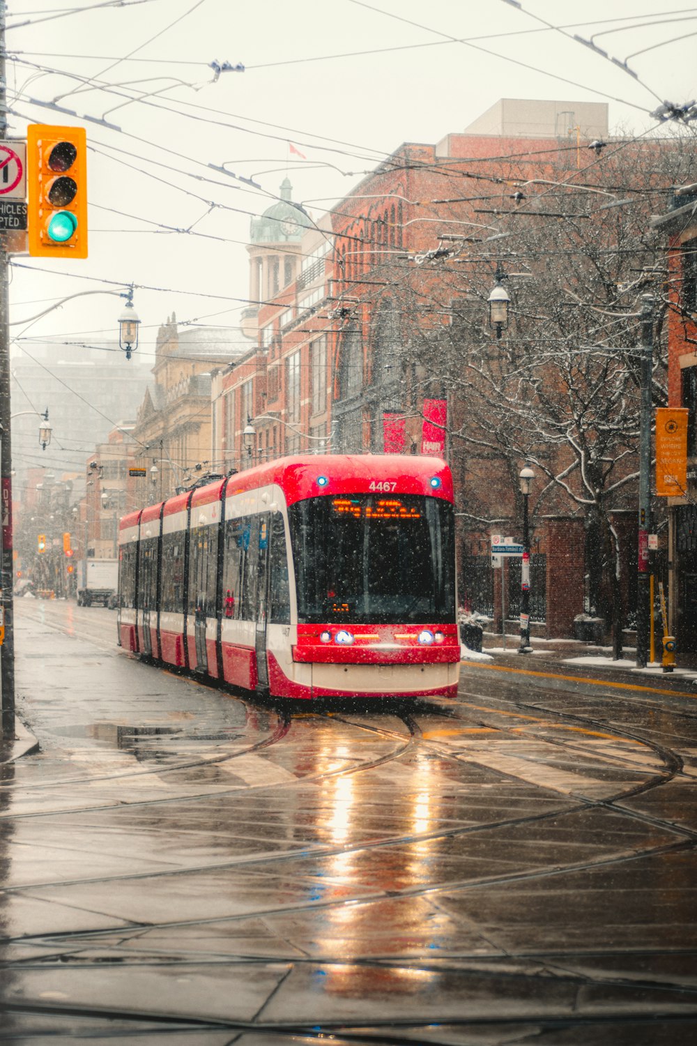 red and white tram on road during daytime