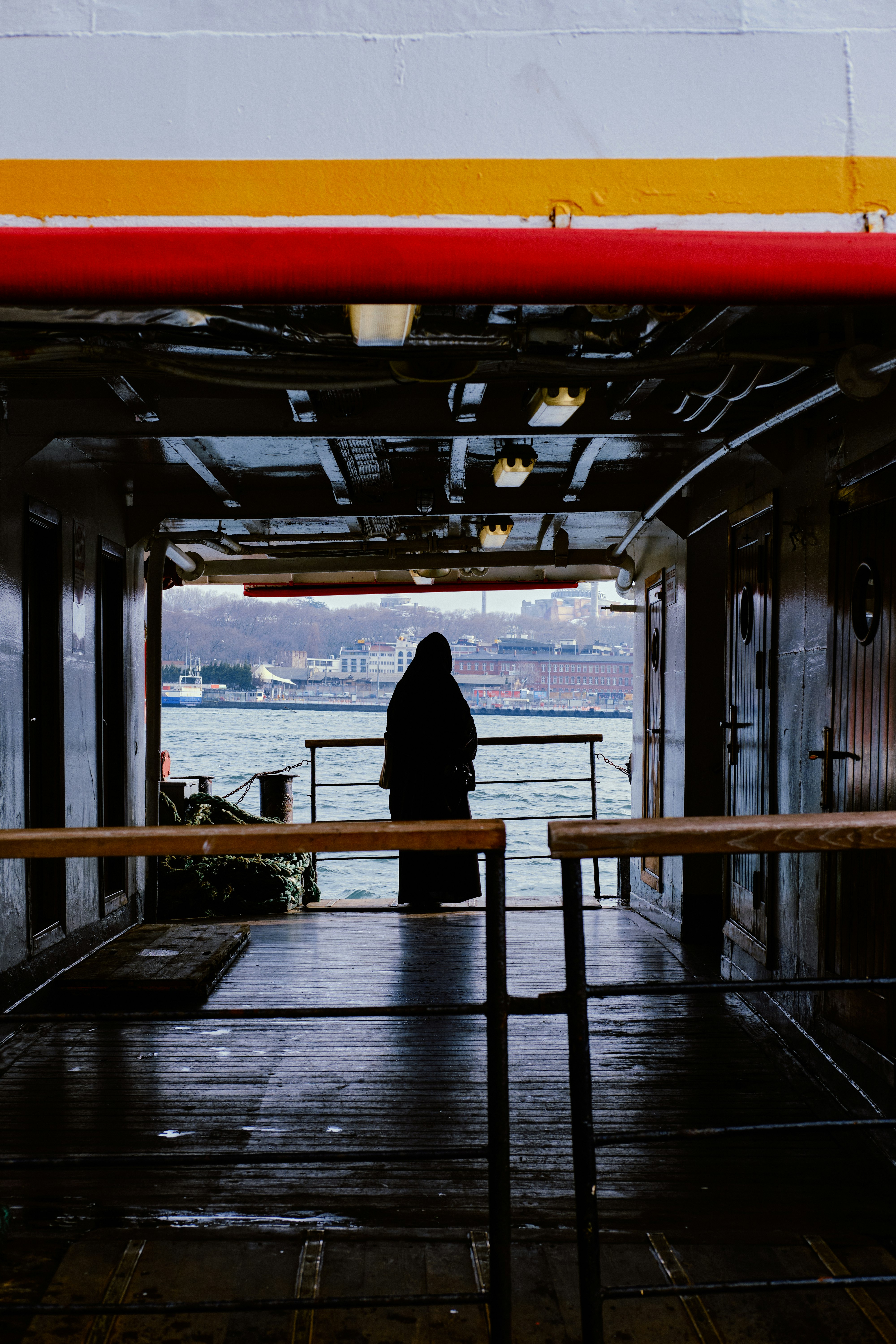 silhouette of person standing on dock during daytime