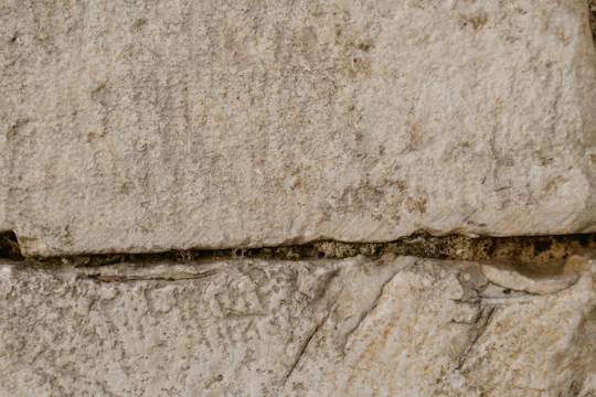Close-up of neatly stacked large granite blocks at the quarry under golden sunlight.