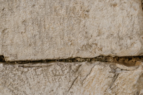 Close-up of textured cantera stone blocks stacked neatly outdoors.