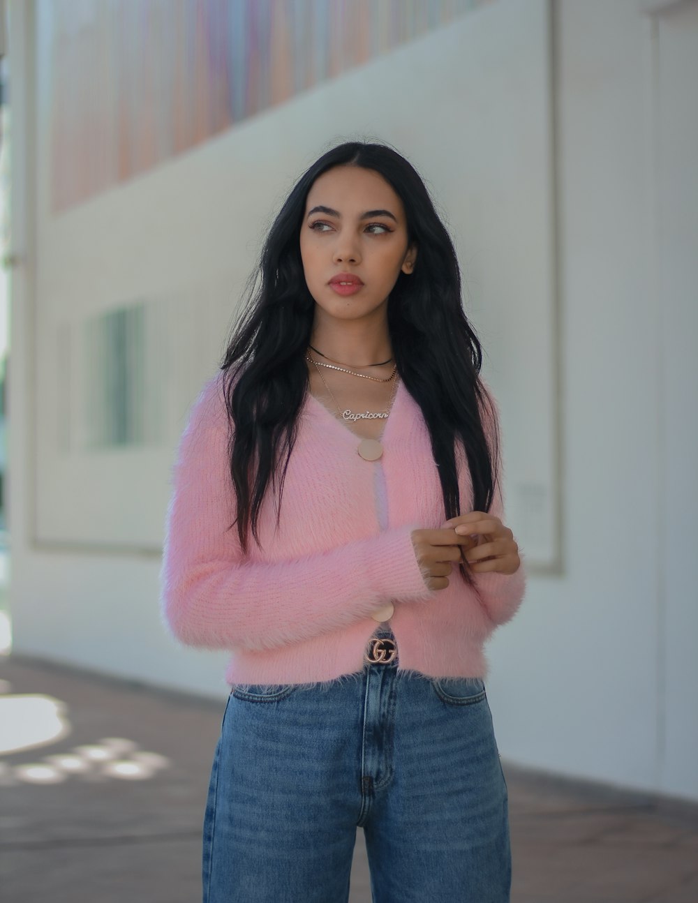 woman in pink sweater and blue denim shorts