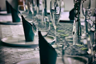 Elegant table setting with multiple personalized wine bottles ready for a special celebration.