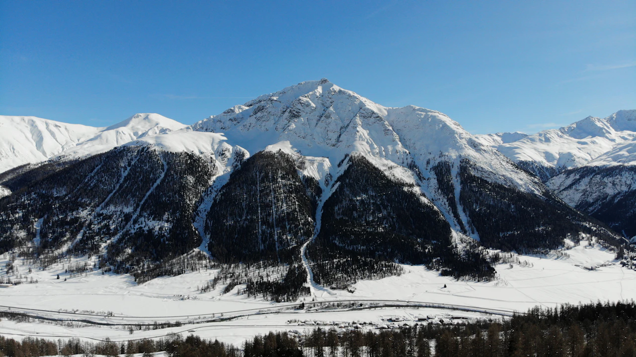 Snow-covered mountain under a clear blue sky