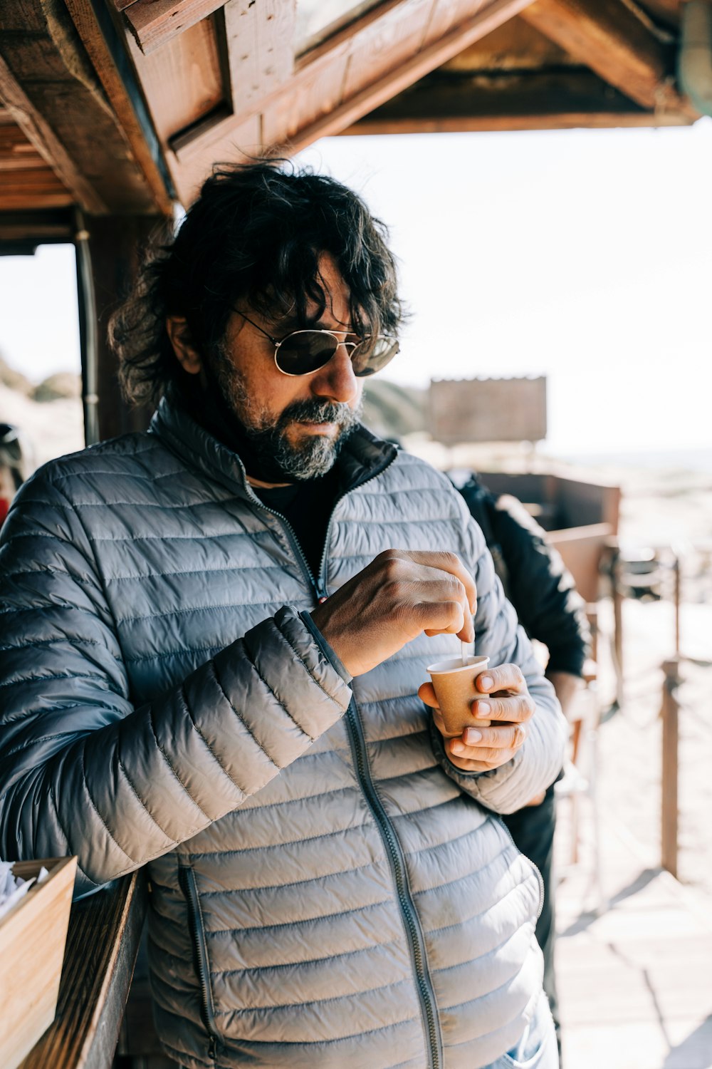 man in black and white striped dress shirt wearing black sunglasses